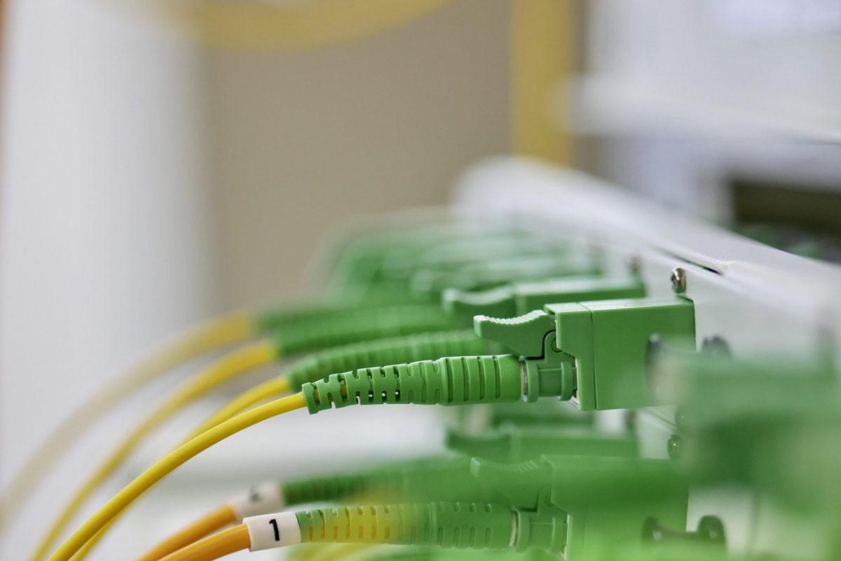 Closeup Fiber optical connector type E2000 APC on ODF/panel for telecommunications